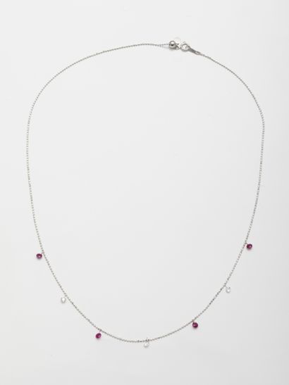 null Necklace in 18k white gold adorned with three diamonds and four rubies in pendants....