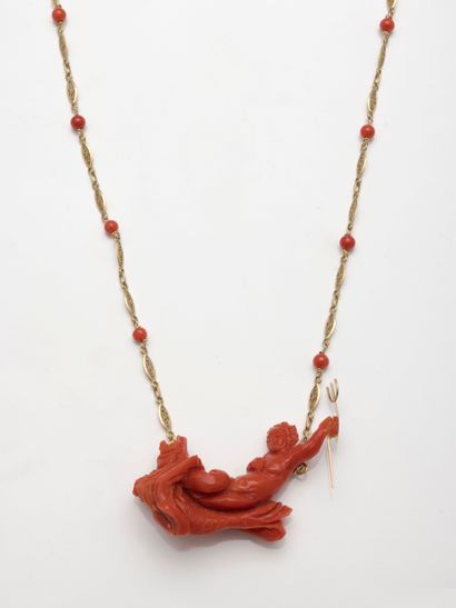 Important pendant in carved red coral representing...
