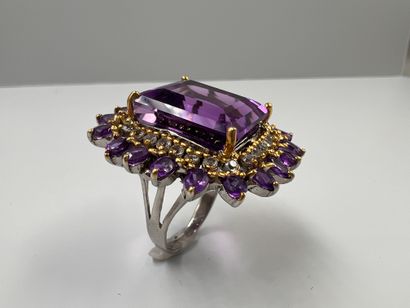 null Silver ring set with an important 25cts amethyst in an openwork setting of round...