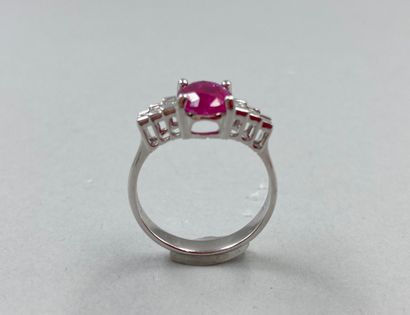 null 18k white gold ring set with a 2cts oval ruby with 3 baguette diamonds on each...