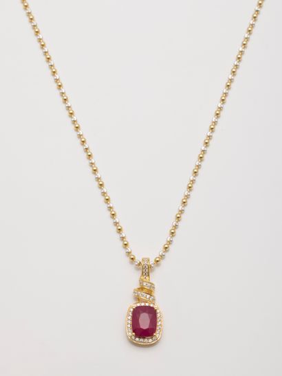 null Pendant in vermeil centered of a ruby in a surround of zircons, held in a silver...
