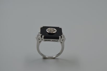 null 18k white gold ring with a cut onyx plate centered by a 1ct diamond in closed...