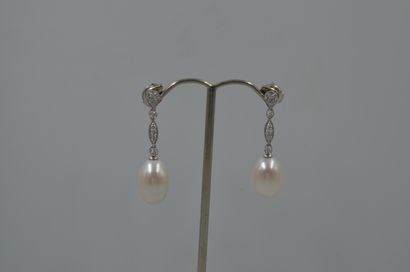 Pair of 18k white gold earrings adorned with...
