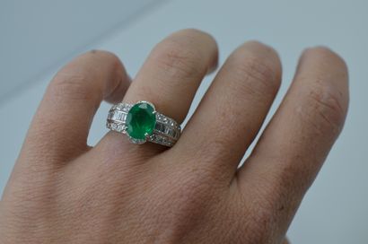 null 18k white gold ring set with an emerald of about 2.75cts and three lines of...