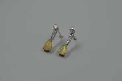 null Pair of 18k white gold earrings set with pear-shaped opals held by a line of...