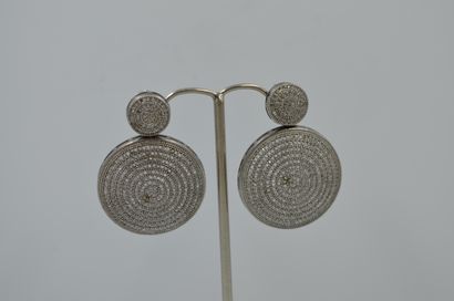 Pair of circular silver earrings entirely...