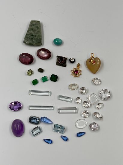 Lot of cut stones on paper including: amethysts,...