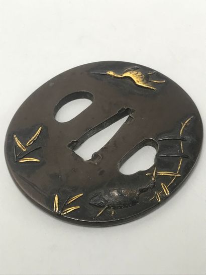 null JAPAN
Copper tsuba with gilded relief decoration showing storks and reeds
DIM...