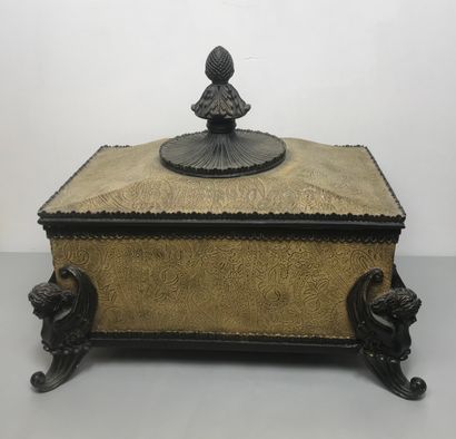 null Wooden chest decorated with carved leafy interlacing. The lid is topped by a...