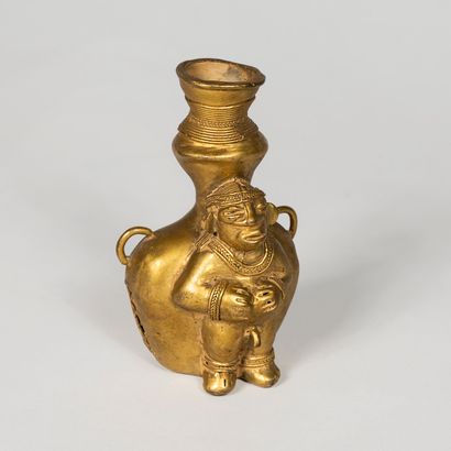 null Poporo container in Tumbaga representing a naked male figure leaning on a large...