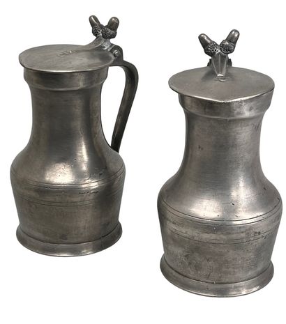 null ETAIN, 18th century ? 
Set of two pewter pitchers of baluster shape, tassel...