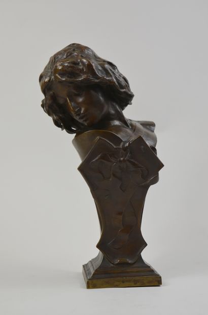 null Small bust in bronze with brown patina representing a young woman with a ribbon...