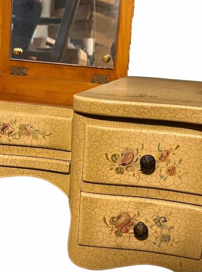 null Wooden dressing table with painted flowers and foliage on a cracked background....