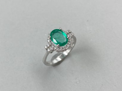 null Art Deco style ring in 18k white gold set with a 1ct oval emerald in a diamond...