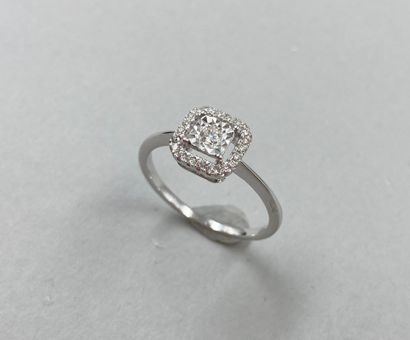 null Ring in 18k white gold, the square openwork bezel centered on a diamond in a...