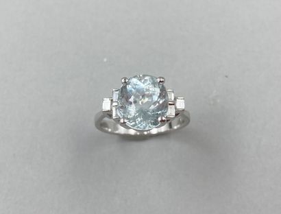null Art Deco style ring in 18k white gold set with an oval aquamarine and 3 baguette-cut...