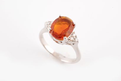 null Bague en or blanc 18k surmontée d'une opale de feu ovale de 2cts environ épaulée...