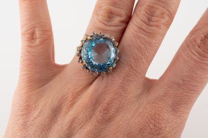 null Bague en argent ornée d'une topaze bleue ronde dans un entourage de pierres...