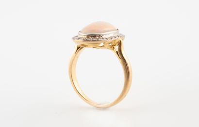 null Bague en or jaune 18k sertie d'une opale en cabochon entourée d'une ligne de...