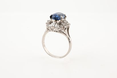 null Platinum skirt ring centered on an oval sapphire of about 4cts in a surround...