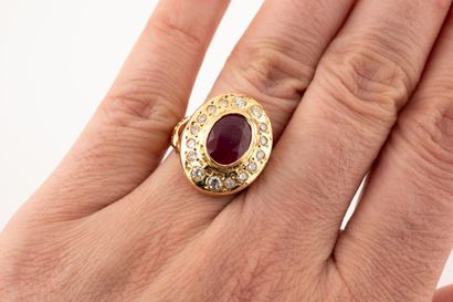 null 18k yellow gold Pompadour ring centered on an oval ruby of about 4cts surrounded...