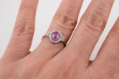 null Ring in 18k white gold set with a pink sapphire of about 1ct in a diamond setting....