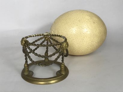null Ostrich (Struthio camelus) egg from a farm, presented on a twisted brass base...