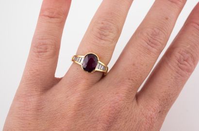 null 18k yellow gold ring set with a beautiful oval ruby of about 2cts, flanked by...
