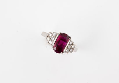 null 18k white gold ring set with an oval ruby of about 2cts flanked by diamonds...