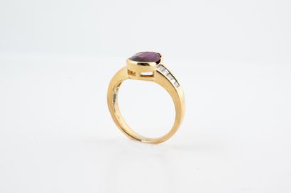 null 18k yellow gold ring set with a beautiful oval ruby of about 2cts, flanked by...