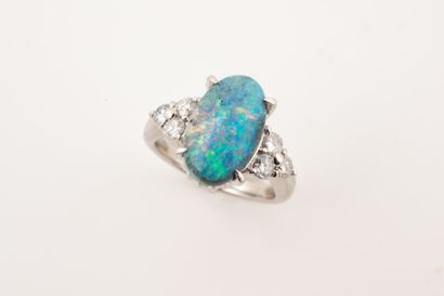 Platinum ring set with an oval opal of about...