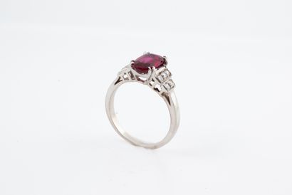 null 18k white gold ring set with an oval ruby of about 2cts flanked by diamonds...