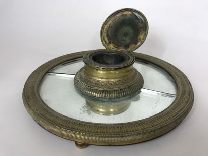 null Inkwell of circular form with mirror bottom and gilded bronze decorated with...