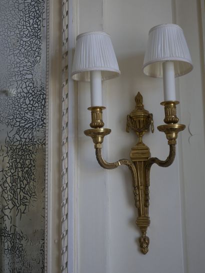 null Pair of Louis XVI style sconces in gilt bronze with two arms of light, the shaft...