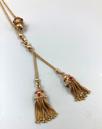 null 18k yellow gold tassel necklace with sliding pattern set with red stones. 
Work...