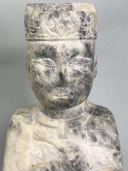 null CHINA, 20th century 
Seated marble dignitary holding a lotus branch in his right...