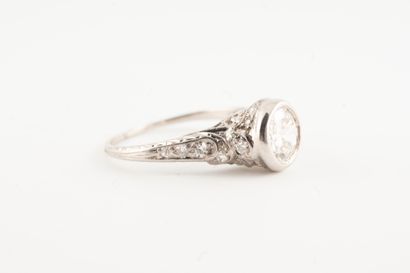 null Platinum ring surmounted by an old-cut diamond in a diamond-set setting for...