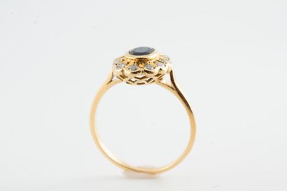 null Pompadour ring in 18k yellow gold, centered on a close-set oval sapphire set...