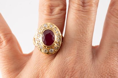 null 18k yellow gold ring centered on an oval ruby weighing approx. 4cts in a setting...