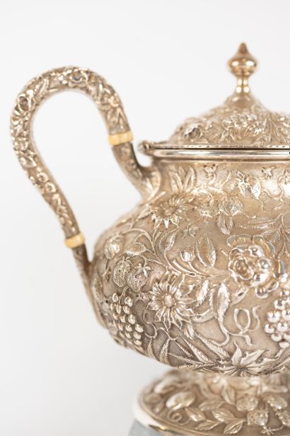 null LORING ANDREWS 
Silver service including pitcher, teapot and sugar pot decorated...