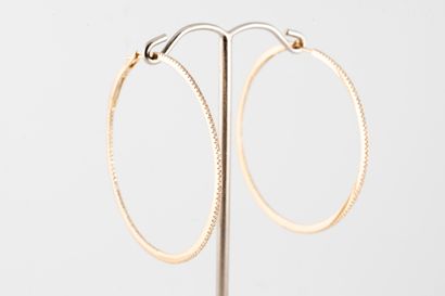 null Pair of fine 18k yellow gold hoop earrings set with diamonds on a line on the...