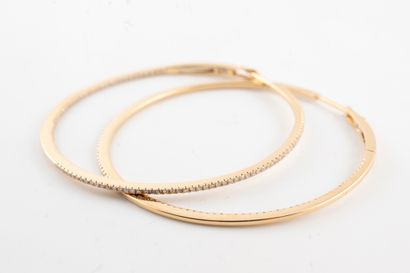 null Pair of fine 18k yellow gold hoop earrings set with diamonds on a line on the...