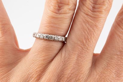 null American wedding band in 18k white gold set with 23 brilliant-cut diamonds totaling...