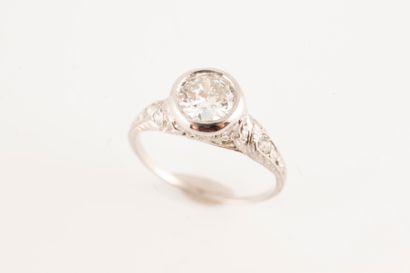 null Platinum ring surmounted by an old-cut diamond in a diamond-set setting for...