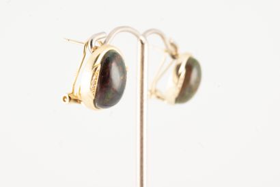 null Pair of vermeil ear studs set with cabochon black opals accented with fine lines...