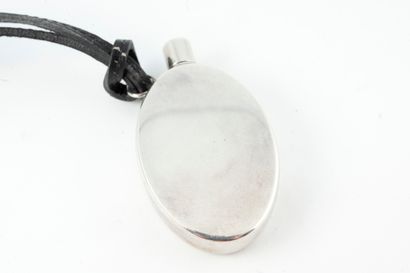 null HERMES 
Oval silver perfume bottle with black leather cord. 
Weight 20gr approx....