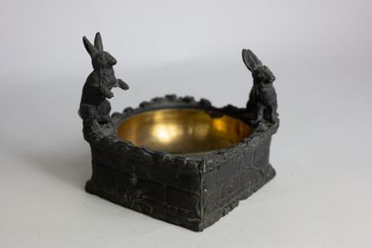 null Regula ashtray decorated with rabbits sitting on a low wall forming an ashtray....