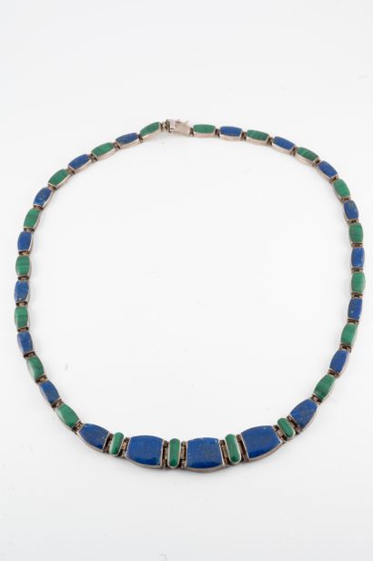 null Silver necklace adorned with alternating malachite and turquoise plaques. 
Gross...
