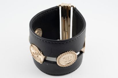 null CHANEL, Circa 2022
Black openwork leather cuff bracelet adorned on one line...