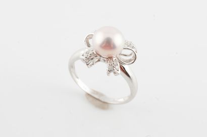 null 18k white gold ring surmounted by a 7mm-diameter pearl set off by a diamond-paved...